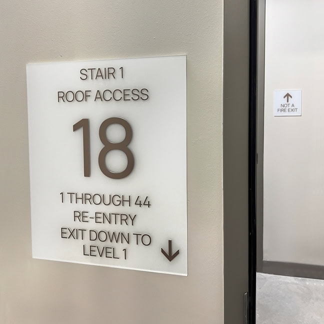 700 River: Interior Stairwell Plaque SWP and Exit Stair Identification ESI.A (Light Plaque)